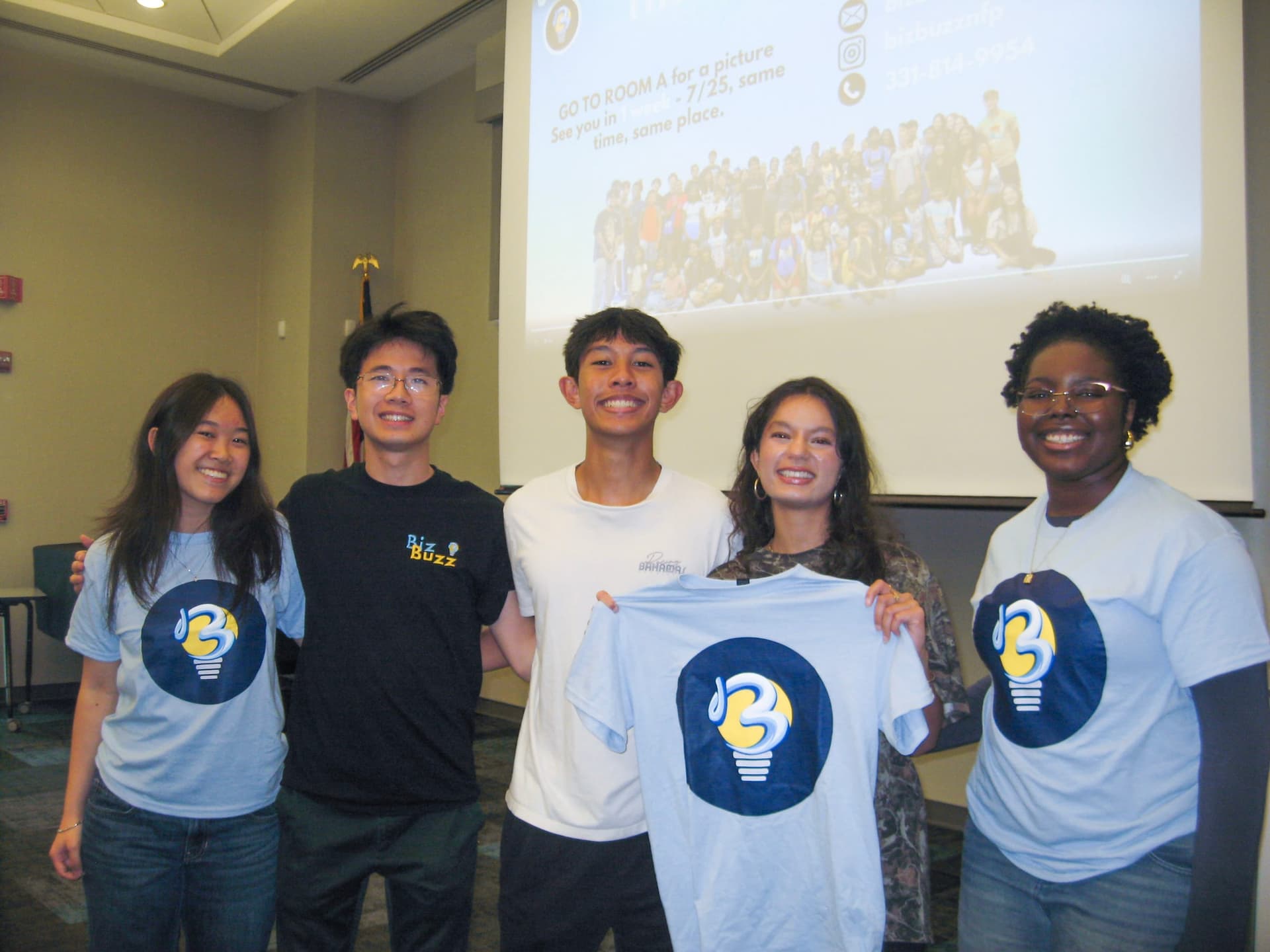 Campers holding up their BizBuzz shirts at the last session of 2025