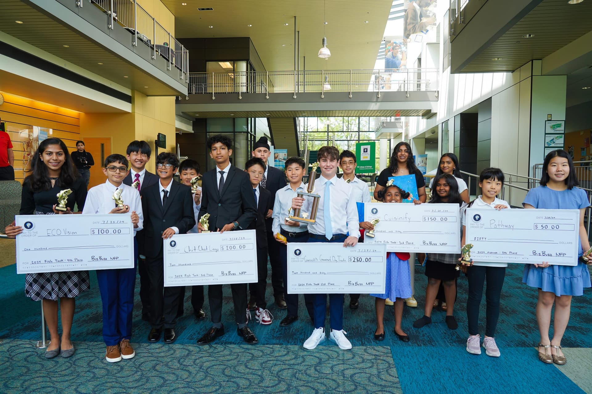The 2024 Fish Tank winners holding their prize checks at College of DuPage